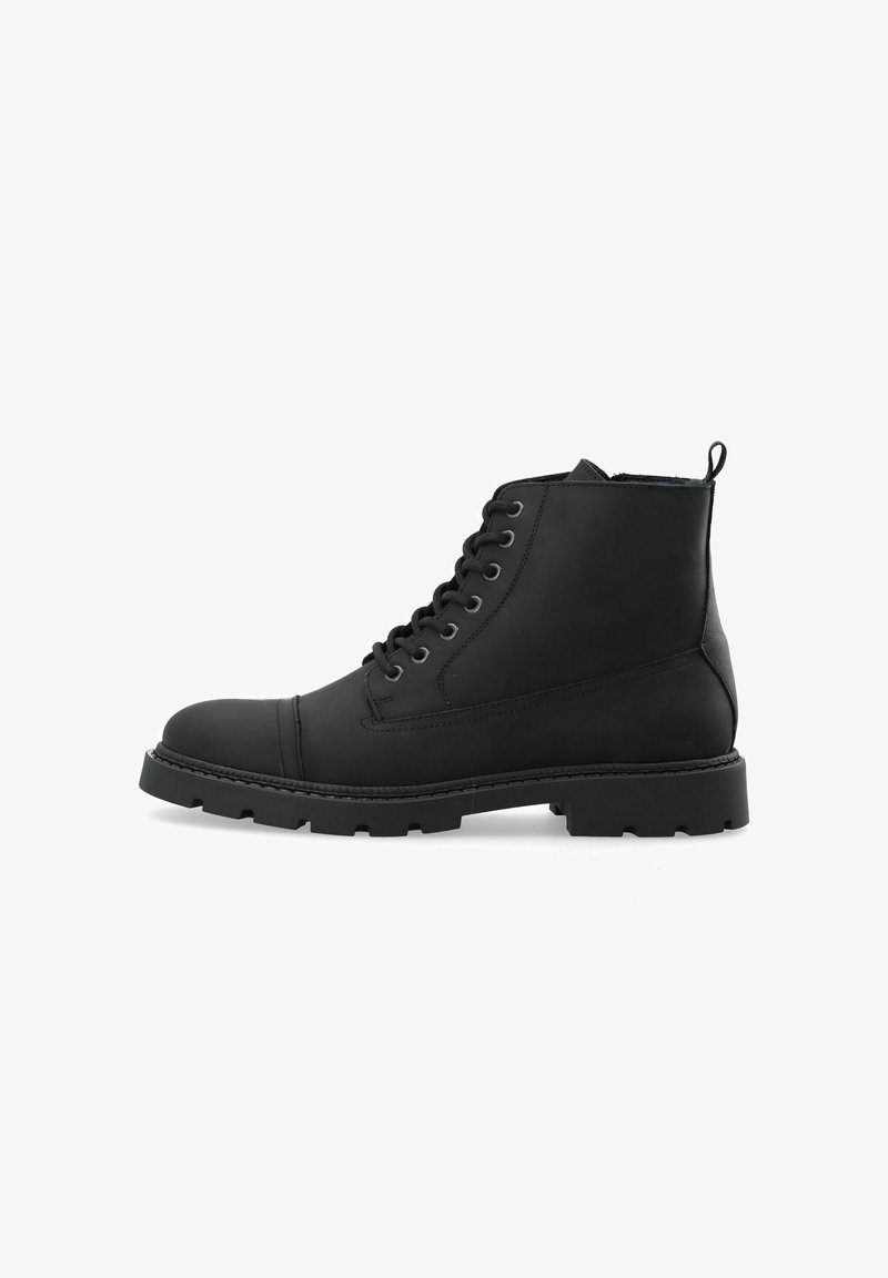 Botte chelsea noire en cuir lisse, bout rond, lacets à l'avant, semelle en caoutchouc durable, et tirant à l'arrière pour un enfilage facile.