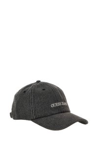 Black denim baseball cap with a curved brim, featuring white embroidered "GUESS JEANS" branding on the front and adjustable strap at the back.