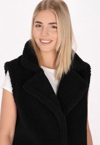 Schmuddelwedda Mellény - schwarz