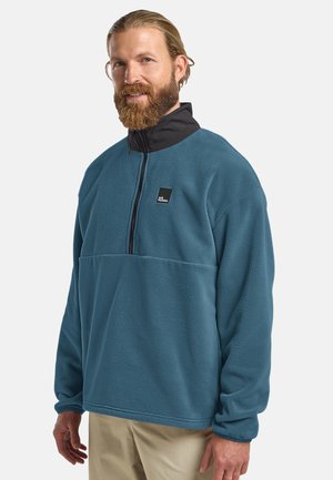 Fleece-Pullover in Teal mit schwarzem Stehkragen, halbem Reißverschluss vorne und einer Brusttasche mit Logo. Weicher Stoff und lässige Passform.