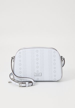 White leather crossbody bag with perforated floral design, silver hardware, and an adjustable strap. Flat shape with smooth texture.