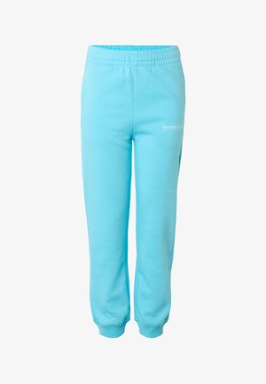 Jasnoniebieskie spodnie dresowe z elastycznym pasem i ściągaczami, z małym białym logo "bruno banani" na górnej lewej nogawce.