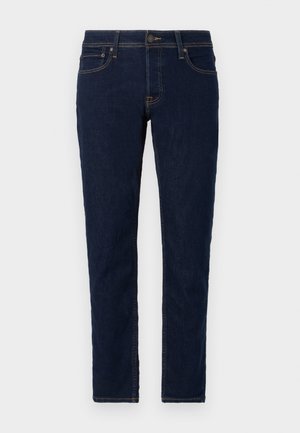 Mørkeblå denim jeans med slim fit. Har standard fem-lomme design, kontrasterende syninger og lukning med metalknap.