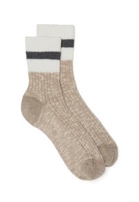 Calze lavorate a maglia beige con un motivo testurizzato. La parte superiore presenta un risvolto bianco con una striscia grigio scuro. Morbide, confortevoli e di lunghezza media, fino al polpaccio.
