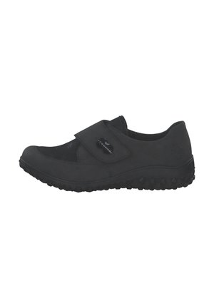 Black flat shoe with textured mesh upper, adjustable strap with snap closure, and rubber sole featuring a treaded pattern.
