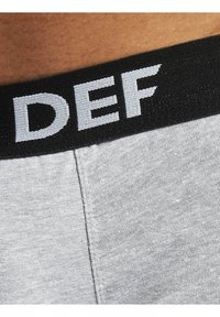 Gray cotton boxer briefs with a black elastic waistband featuring white "DEF" lettering and a smooth, soft texture.