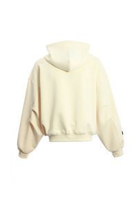 Sudadera con capucha en crema, con mangas oversized, puños y dobladillo acanalados. Textura suave, diseño simple y sin patrones ni acentos visibles.