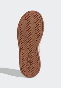 Brown rubber sole with zigzag pattern and "adidas" logo embossed. White upper edge visible with a smooth texture.