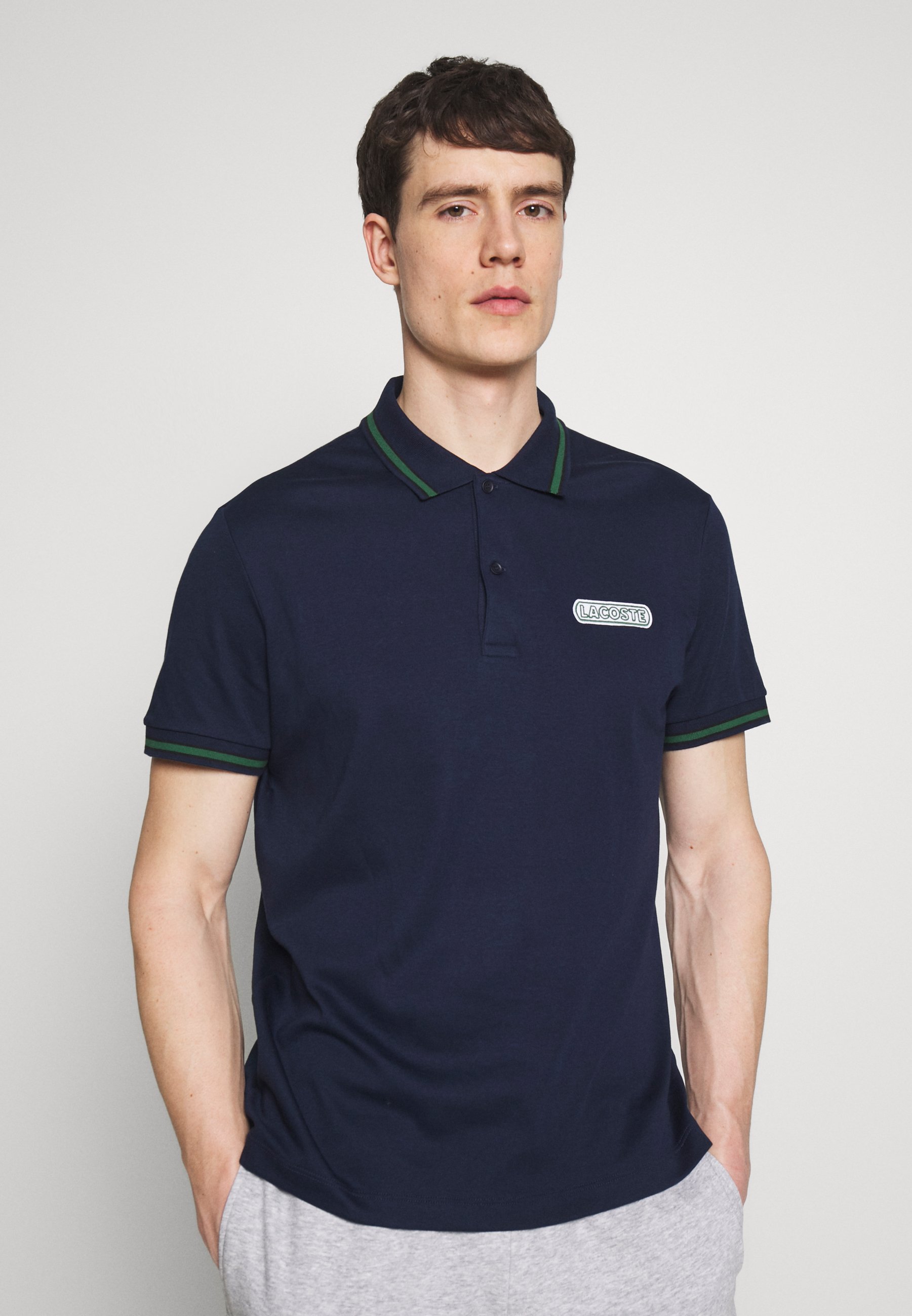 black and green lacoste shirt