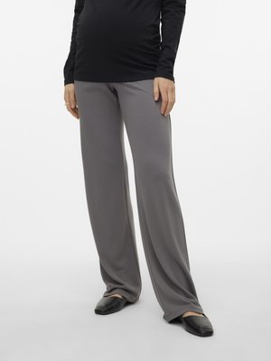 Gray, wide-leg pants with a smooth texture, paired with a black fitted long-sleeve top and black flat shoes. Clothing fits snug at waist.