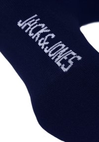 Navy blue cotton sock featuring white “JACK & JONES” logo; smooth texture with knitted design, ideal for casual wear.