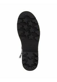 Semelle en caoutchouc noir avec un motif de star, surface texturée et impression de logo. Forme ovale avec un design de grip structuré.