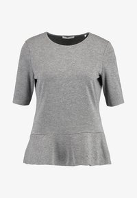 Blusa de manga corta con pequeños cuadros en blanco y negro, escote redondo y detalle de bajo acampanado.