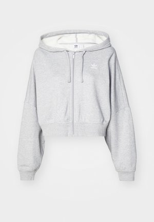 Light grey cropped zip-up hoodie with a drawstring hood, featuring a white logo on the left chest and ribbed cuffs. Soft material.