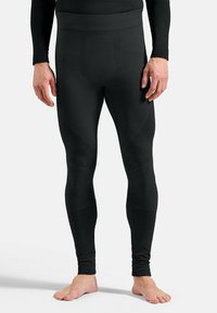 Black thermal leggings made of textured fabric with a fitted design, featuring a wide waistband and reinforced panels for support.