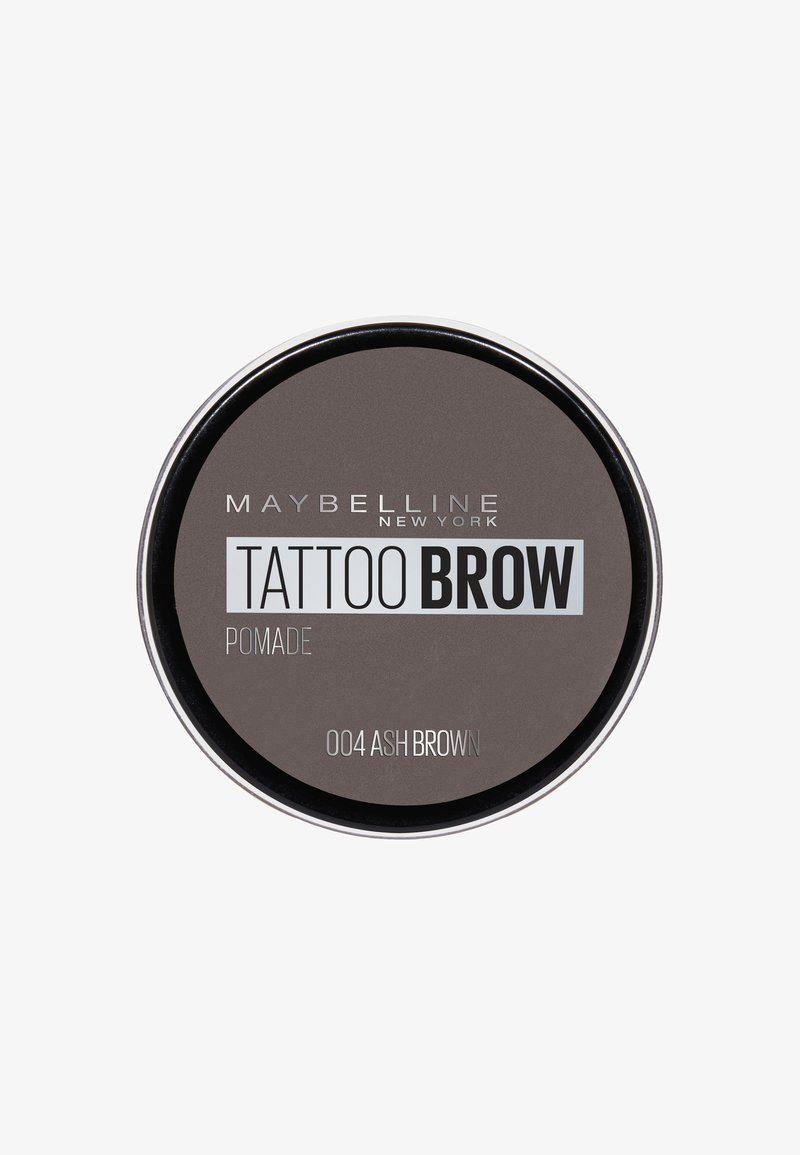 Pomata per sopracciglia Tattoo di Maybelline in una confezione rotonda, colore castano scuro cenere, texture liscia, con scritte argentate e bianche sul coperchio.