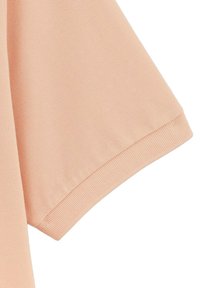Korte mouw top van zacht perzikkleurig materiaal met geribbeld zoom en een gemêleerd uiterlijk, met een ontspannen pasvorm en gladde, lichte stof.