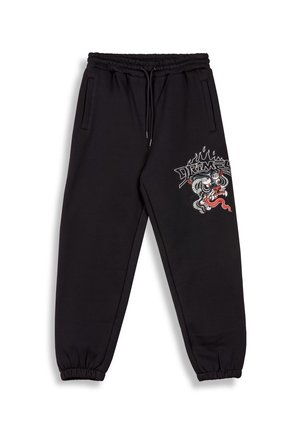 Black sweatpants with an elastic waistband and cuffs, featuring side pockets. Decorative graphic of a dragon and flames on the left leg.