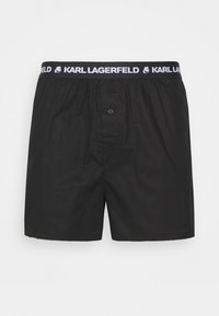 Čierne boxerky vyrobené z bavlny, s elastickým pásom a bielym logom "KARL LAGERFELD" a detailom na prednom zapínaní.