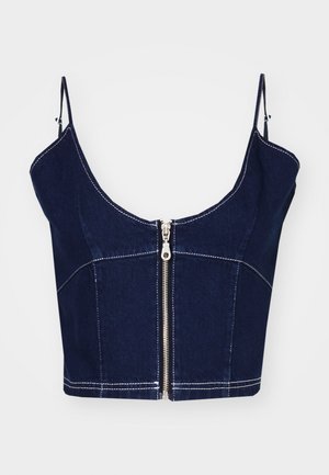 Temno moder denim top s kratkimi naramnicami. Ima sprednji zadrgo in kontrastno belo šivanko. Čista, prilega se silhueti z oblikovanim dizajnom.