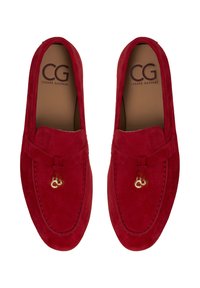 Par crvenih loafera od brušene kože sa zlatnim metalnim ukrasima na vrhu, uložci s markom "CG Cesare Gaspari."