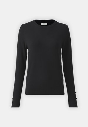Svart tröja med rund halsringning, långa ärmar och tre dekorativa knappar på varje ärm. Tillverkad av mjukt, slätt material.