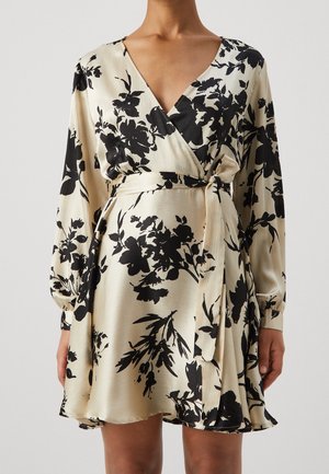 Cream satin wrap dress with black floral print, long sleeves, V-neck, and tied waist belt.