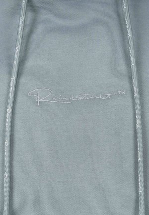 Lichtblauwe sweatshirt met een aansluitend ontwerp, voorzien van een ritssluiting aan de voorkant en een reliëflogo. Gladde textuur met subtiele stiksels.