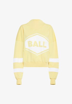 Kollane lühike kapuutsiga sweatshirt, mille esiküljel on suur valge "BALL" logo ja valged triibud varrukatel. Pehme kangast tekstuur.