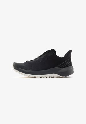 Black athletic shoe with a breathable mesh upper, textured design, gray sole, and reinforced heel. Features lacing system and treaded outsole.