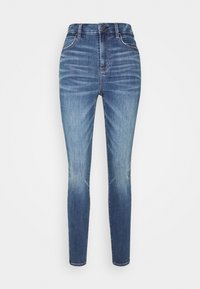 Slim-fit, högmidjade jeans i medelblå denim med lätt blekning. Har fem fickor, bälteshällor och en framknäppning.