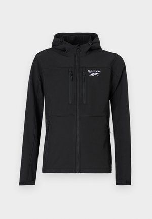 Schwarze Reebok-Hoodiejacke mit Frontreißverschluss, zwei Reißverschlusstaschen auf der Brust, zwei seitlichen Reißverschlusstaschen und Logo auf der linken Brust.