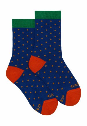 Calzini blu con polsini verdi a coste e accenti arancioni sulla punta e sul tallone, caratterizzati da un motivo di piccole macchie dorate su tutta la superficie.