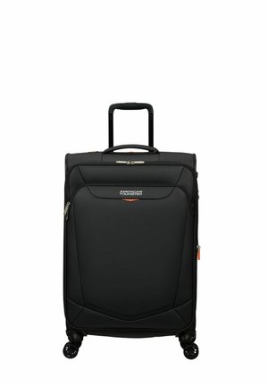 Black spinner suitcase with a textured exterior, retractable handle, dual wheels, and orange zipper accents. Features branded logo on front.