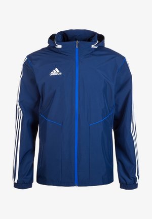 Veste Adidas bleu marine avec capuche, fermeture éclair bleue à l'avant, trois bandes blanches sur les manches et logo Adidas sur la poitrine.