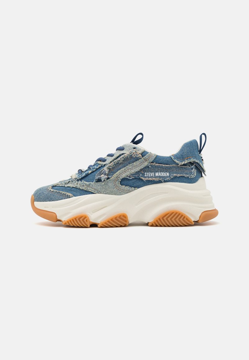 Denim sneaker featuring a layered blue design, frayed accents, a white chunky sole, and a rubber brown outsole for grip.