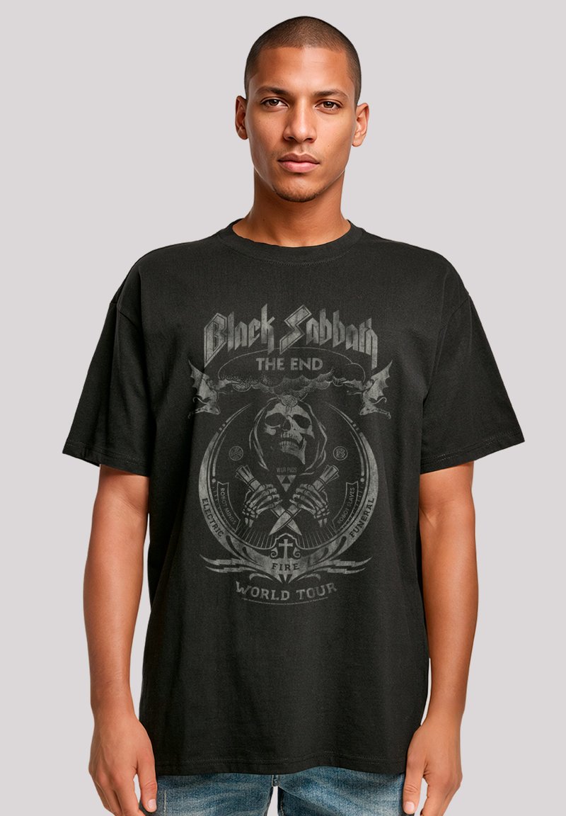 Black cotton t-shirt featuring a graphic design with a skull, bat accents, and text "Black Sabbath The End World Tour" in gray.