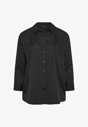 Mustat nappipaidat, joissa on pilkkukuosi, pitkät hihat, klassinen kaulus ja rento istuvuus, jossa on hieman kaareva helma.