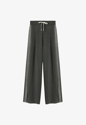 Wijdvallende sweatpants van donkergrijs materiaal, met een witte trekkoord en verticale witte strepen langs de zijkanten. Zachte textuur, casual ontwerp.