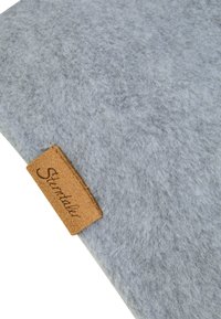 Light gray felt fabric with a small brown leather tag stitched on the corner, featuring the word "Sterntaler" in cursive.