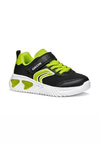 Scarpa da ginnastica nera e verde lime con tomaia in mesh e suola bianca. Presenta una chiusura a strappo e accenti arrotondati sulla suola.