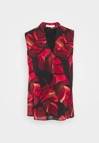 Ärmlös blus med djup V-ringning, med stora röda och bruna tropiska bladmönster på svart bakgrund.