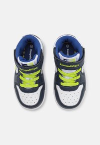 Navy and white athletic high-top shoes with neon green laces, perforated toe, and velcro strap. Textured leather upper and padded collar.