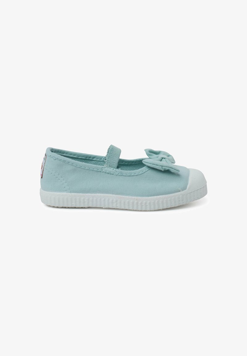 Light blue canvas ballet flat with a bow accent, elastic strap, and white rubber sole. Rounded toe, smooth texture, minimalistic design.