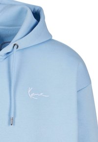 Light blue hoodie with a drawstring hood, silver eyelets, and a white embroidered logo on the chest. Soft, solid fabric texture.