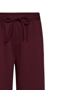 Bordeaux sweatpants van zachte stof, met een elastische tailleband met een trekkoord en een taps toelopend ontwerp.