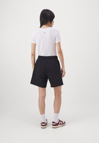 Jordan Pantalon de survêtement - black/white