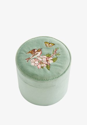 Round, soft green velvet storage box with floral and bird embroidery on the lid. Features a smooth texture and subtle stitching detail.