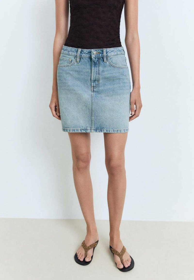 Denim mini krilo v svetlo modri barvi z ravnim krojem, sprednjimi žepi in zadrgo. Združeno z črnimi japankami z okrasnim trakom.