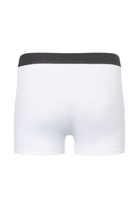 Weiße Boxershorts aus weichem Stoff mit einem schwarzen elastischen Bund, ausgestattet mit einer glatten Textur und einem einfachen, nahtlosen Design.